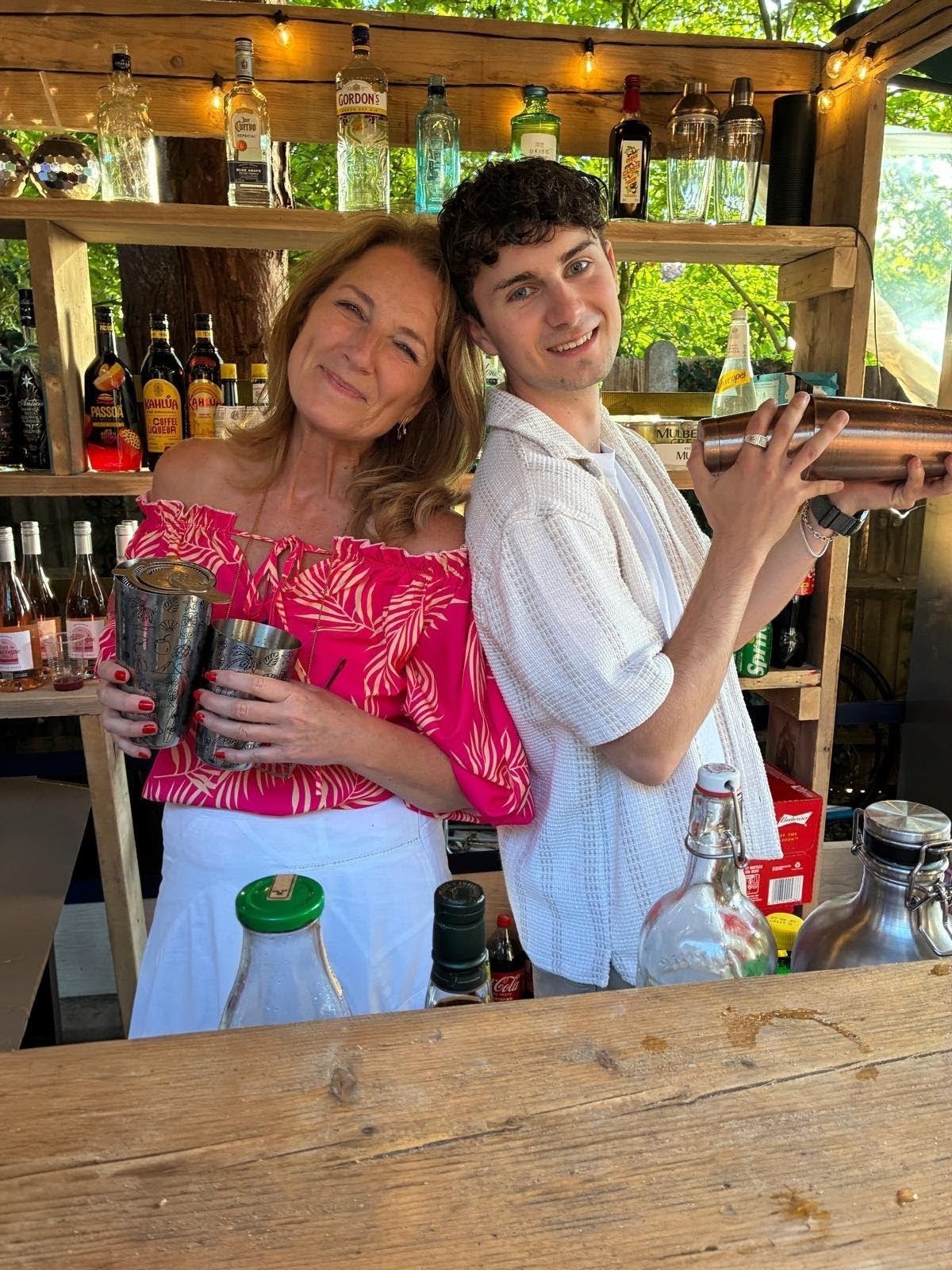 Two people mixing cocktails behind a Bar Buddy