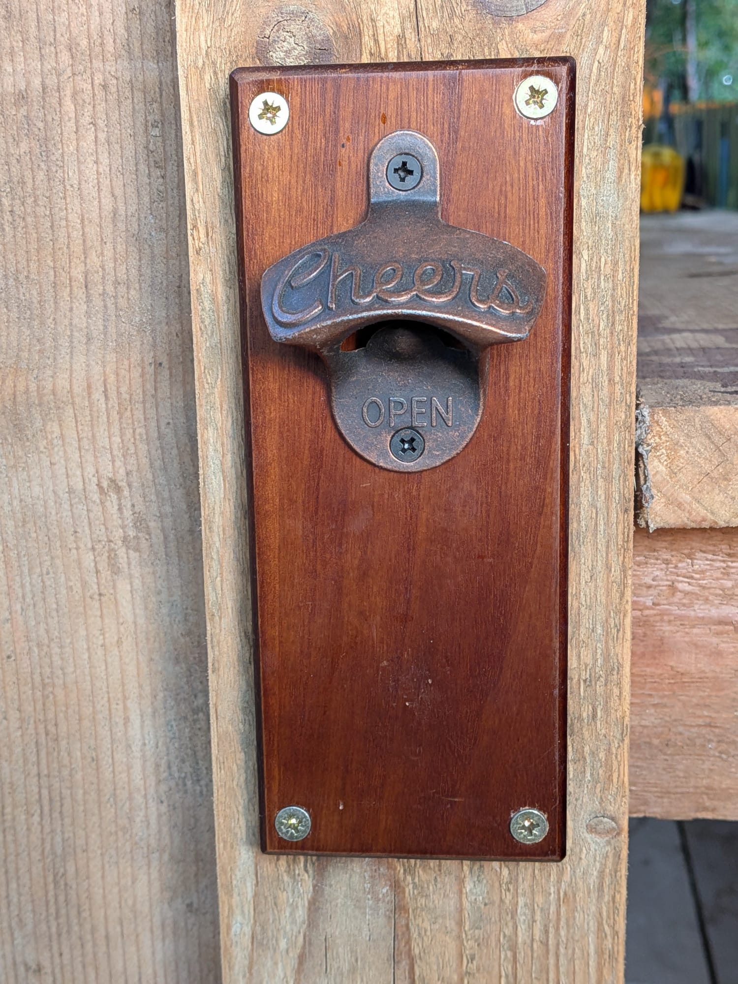 Cast iron 'Cheers' bottle opener mounted on a wooden Bar Buddy post