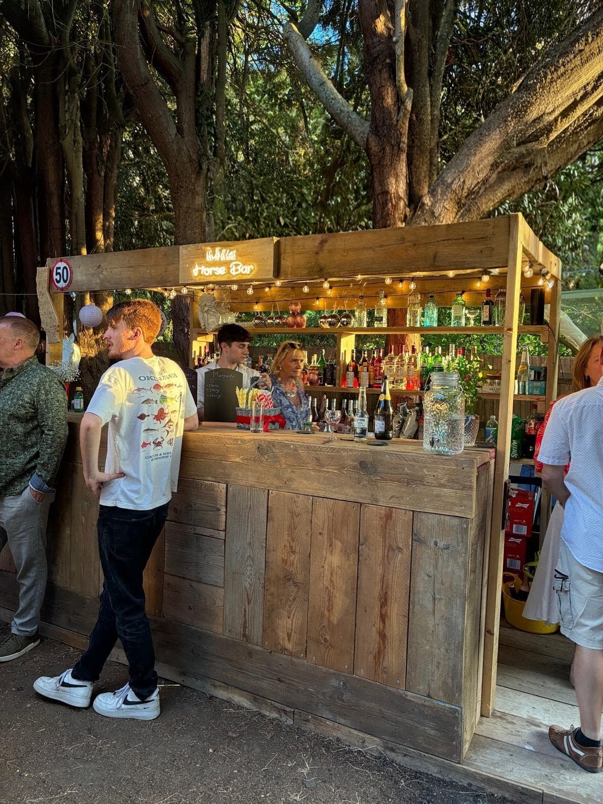 Garden Forge Buddies wooden bar in use at an outdoor party
